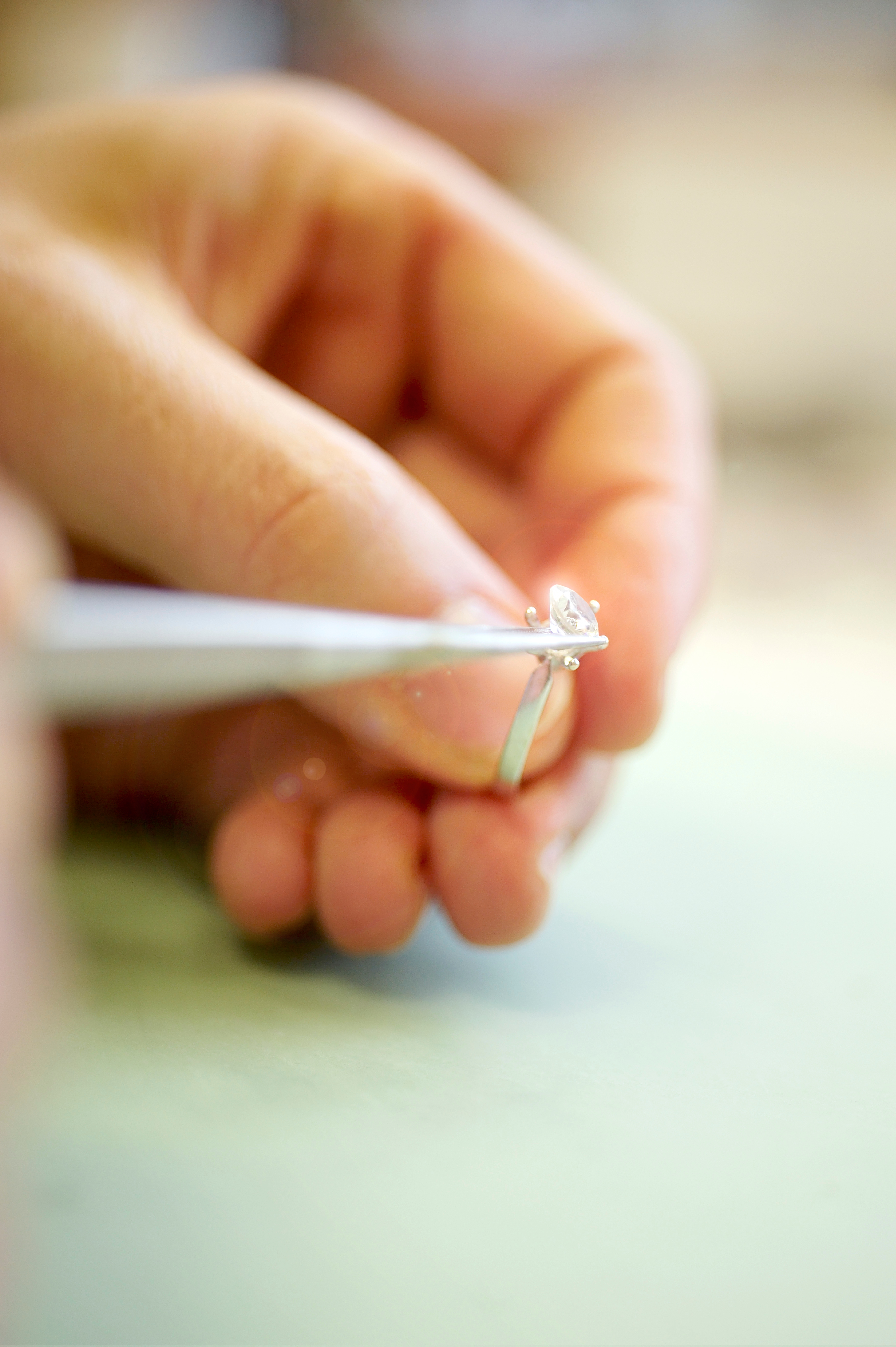 Close-up of jeweler setting a diamond stone